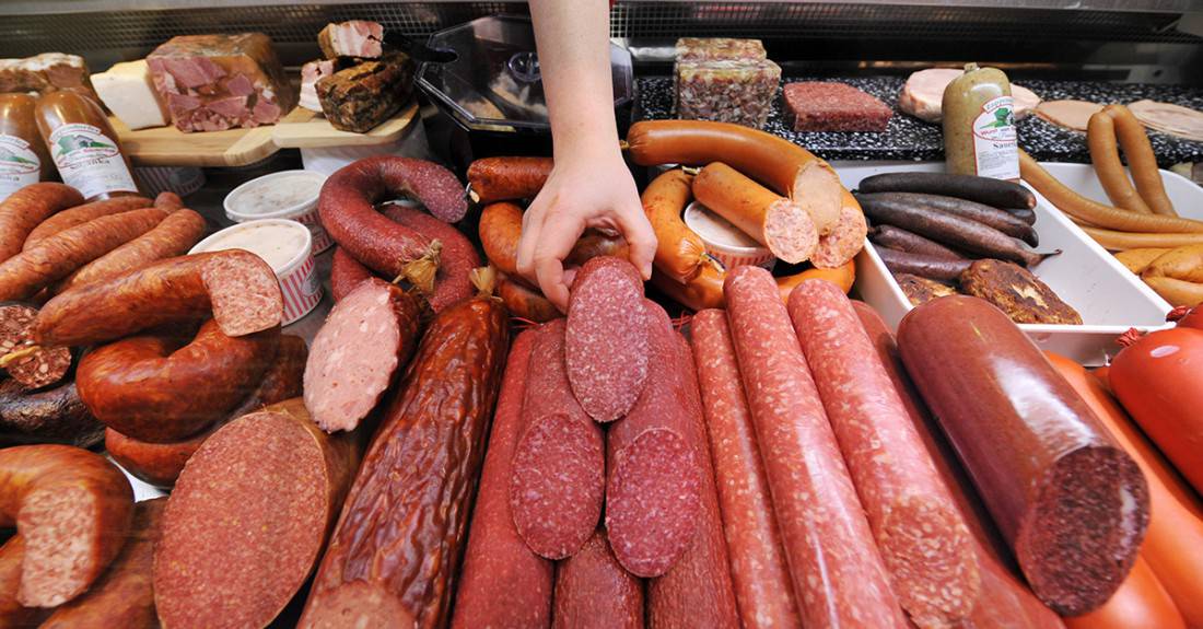 A saleswoman rearranges a display of German salami, among other meat products, at a meat shop in Berlin on January 13, 2009. German butchers now claim that salami was invented not in Italy, as is widely assumed, but in Germany. While the word "salami" originally comes from "salare", the Italian word for "to salt", the art of making salami was born not in Bologna, Italy, but Mecklenburg in north-eastern Germany, according to new research, published in a German newspaper on January 13. AFP PHOTO JOHN MACDOUGALL