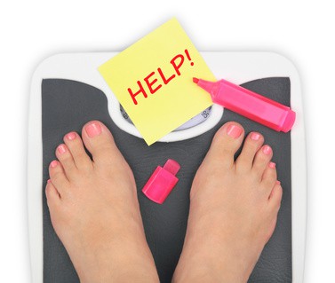 Woman' s feet on bathroom scale